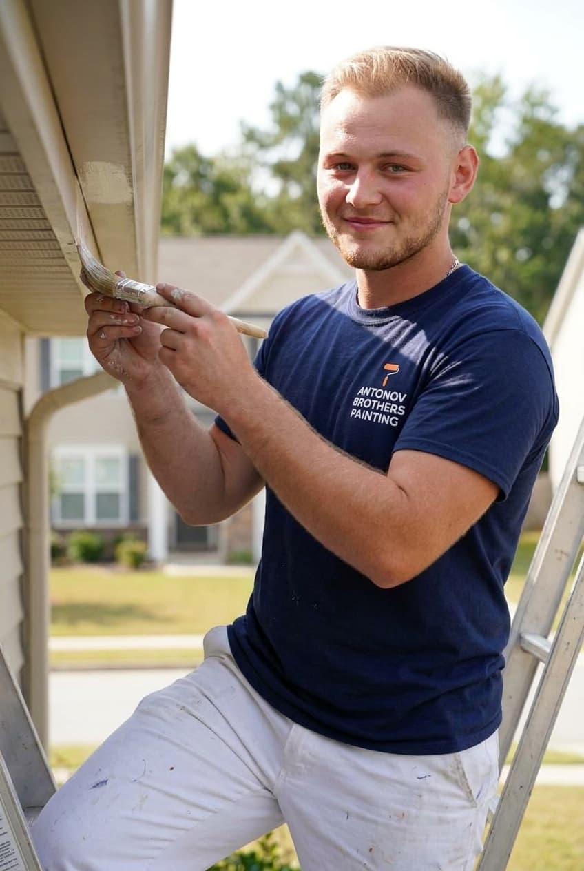 Brushing fresh paint on exterior fascia and trim — exterior painting Jacksonville