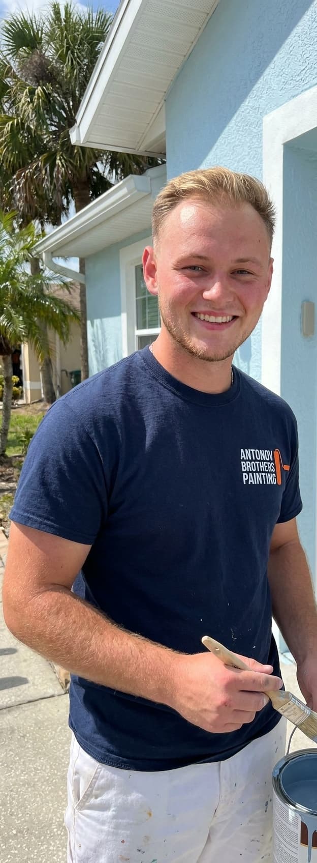 Antonov Brothers painter in front of a freshly painted Florida home
